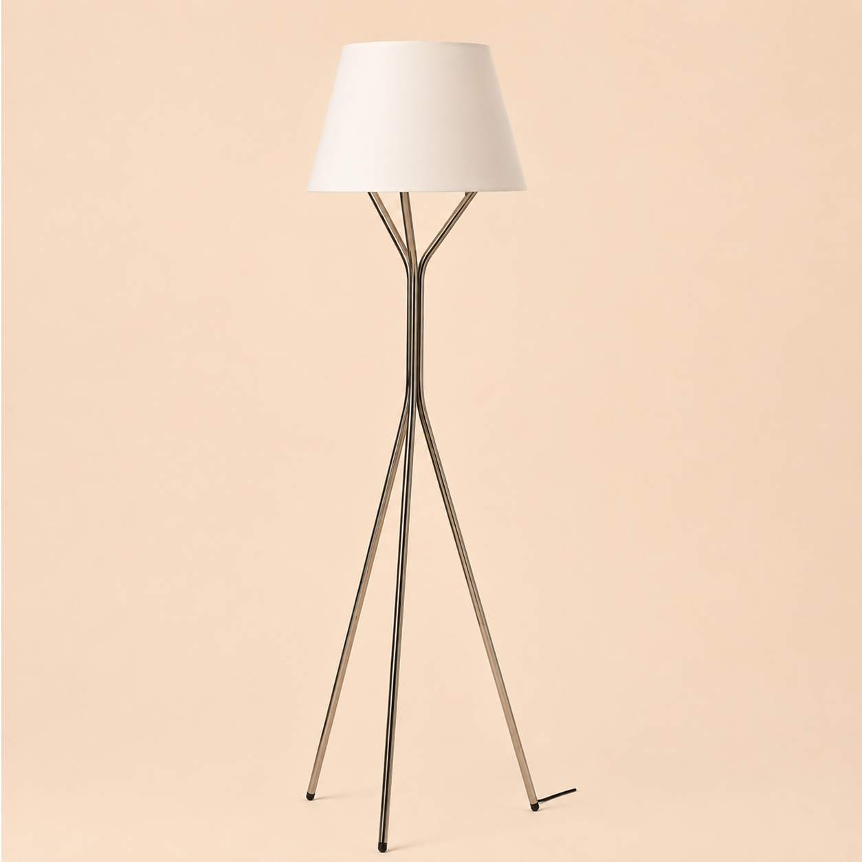 Aster Tripod Floor Lamp with a white fabric shade creating warm ambient lighting in a modern living room.