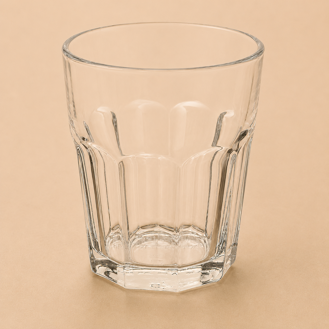 Front-facing view of a short AquaClear Glass Tumbler centered on a beige studio backdrop.